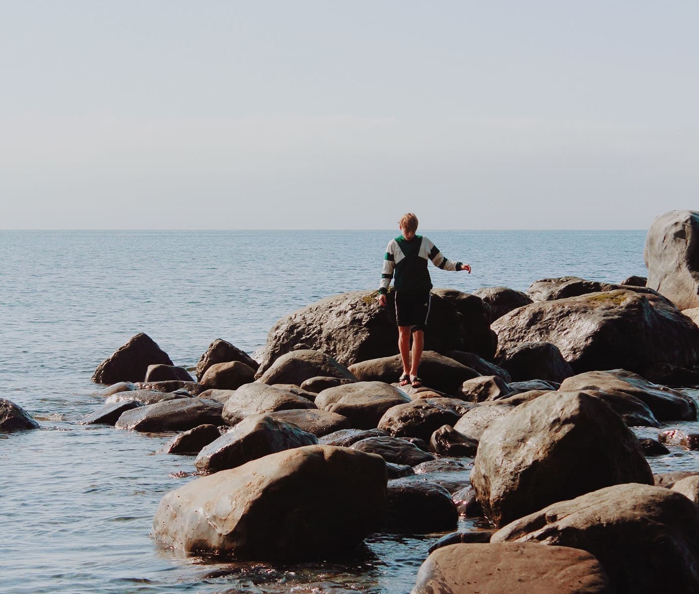 Boy walking on stones